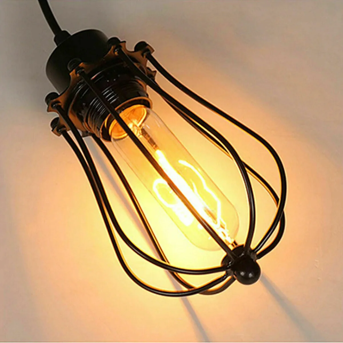 Black industrial spider pendant light with multiple balloon cage shades hanging from a central rose