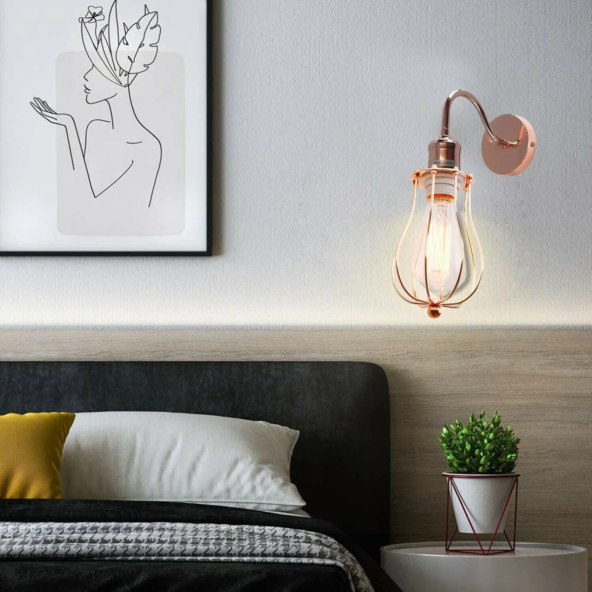 Metal wall sconce with industrial cage shade, mounted on wall, ready for an E27 bulb, adding rustic elegance to interior