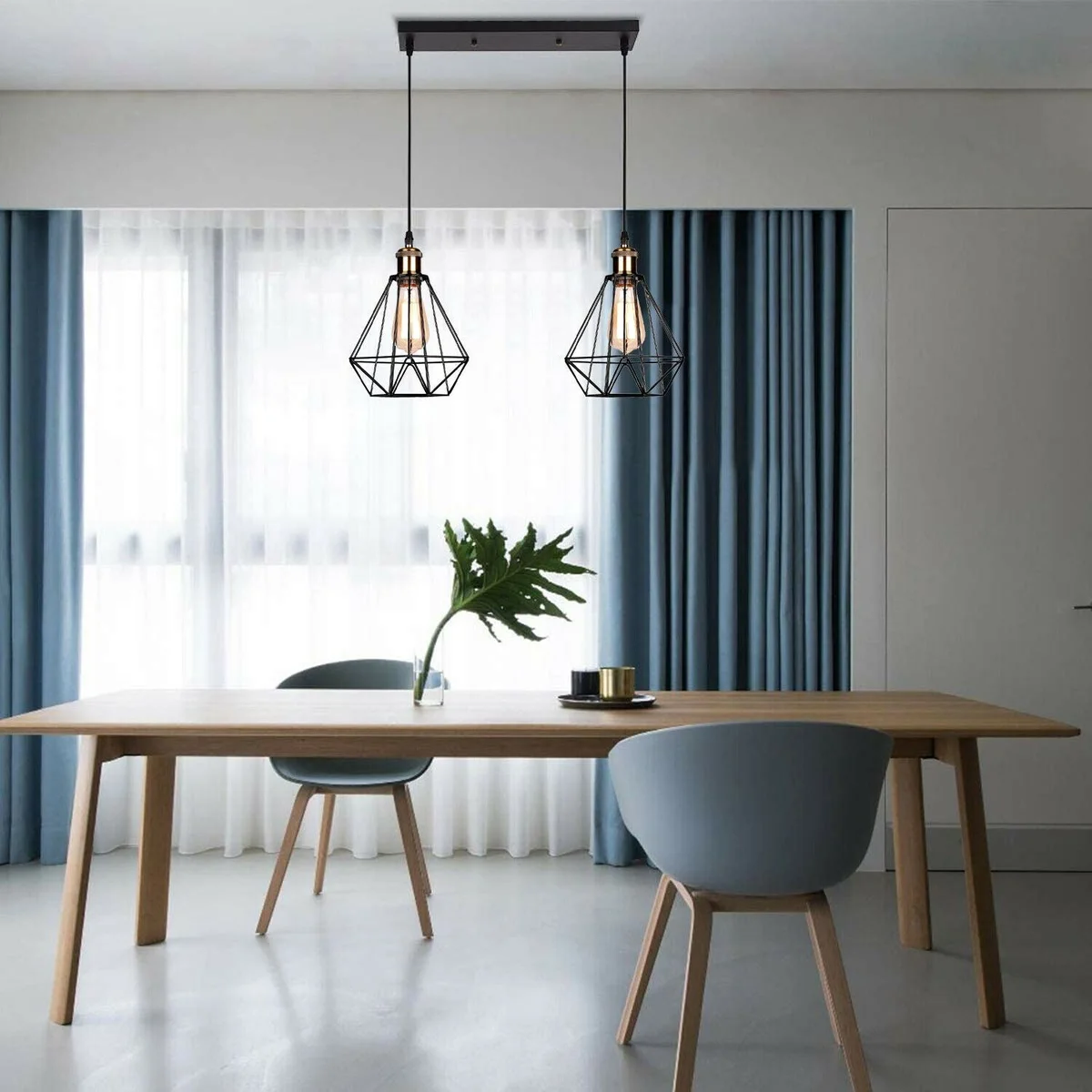 Black industrial ceiling pendant with two metal wire cage heads hanging from 95cm PVC cable, 30cm x 2.5cm plate.