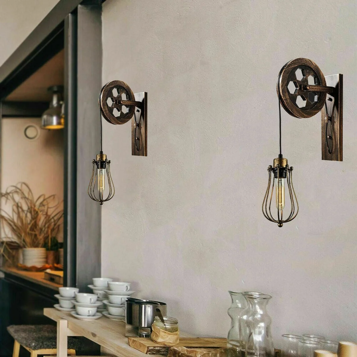 Retro industrial wall lamp with a black pulley wheel, iron cage shade, adjustable cable – stylish loft‑style lighting.