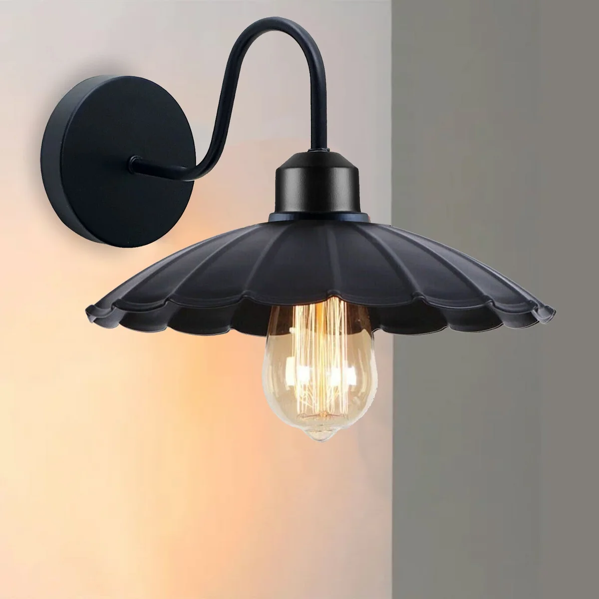 Rustic wall light with black metal umbrella shade on a plain wall, featuring a sleek metal frame and dimmable bulb socket.