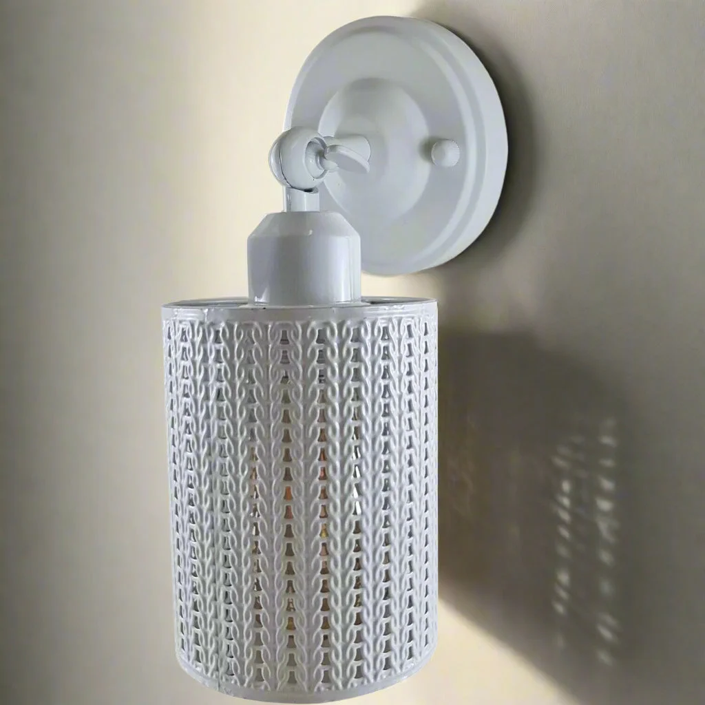 White vintage wall sconce with metal cylindrical shade, adjustable arm, mounted on wall, ready for an E27 bulb.