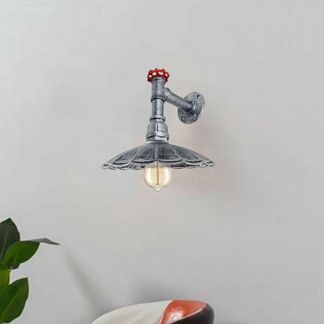 Vintage industrial wall sconce with metal body and umbrella shade hanging on wall