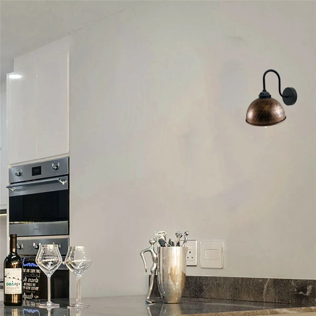 Rustic wall light: metal retro lamp with dome shade, E27 holder and light arm on a dark wall.