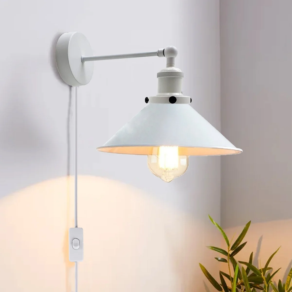 White plug in wall sconce with iron frame, simple white lamp shade and wall mount.