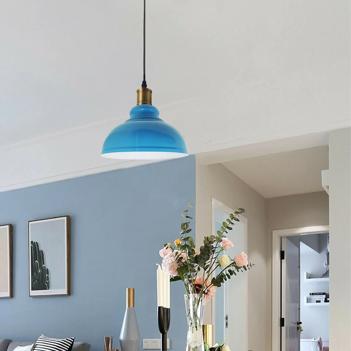 Modern metal pendant lamp with black metal shade, PVC cable and ceiling plate, hanging over a room