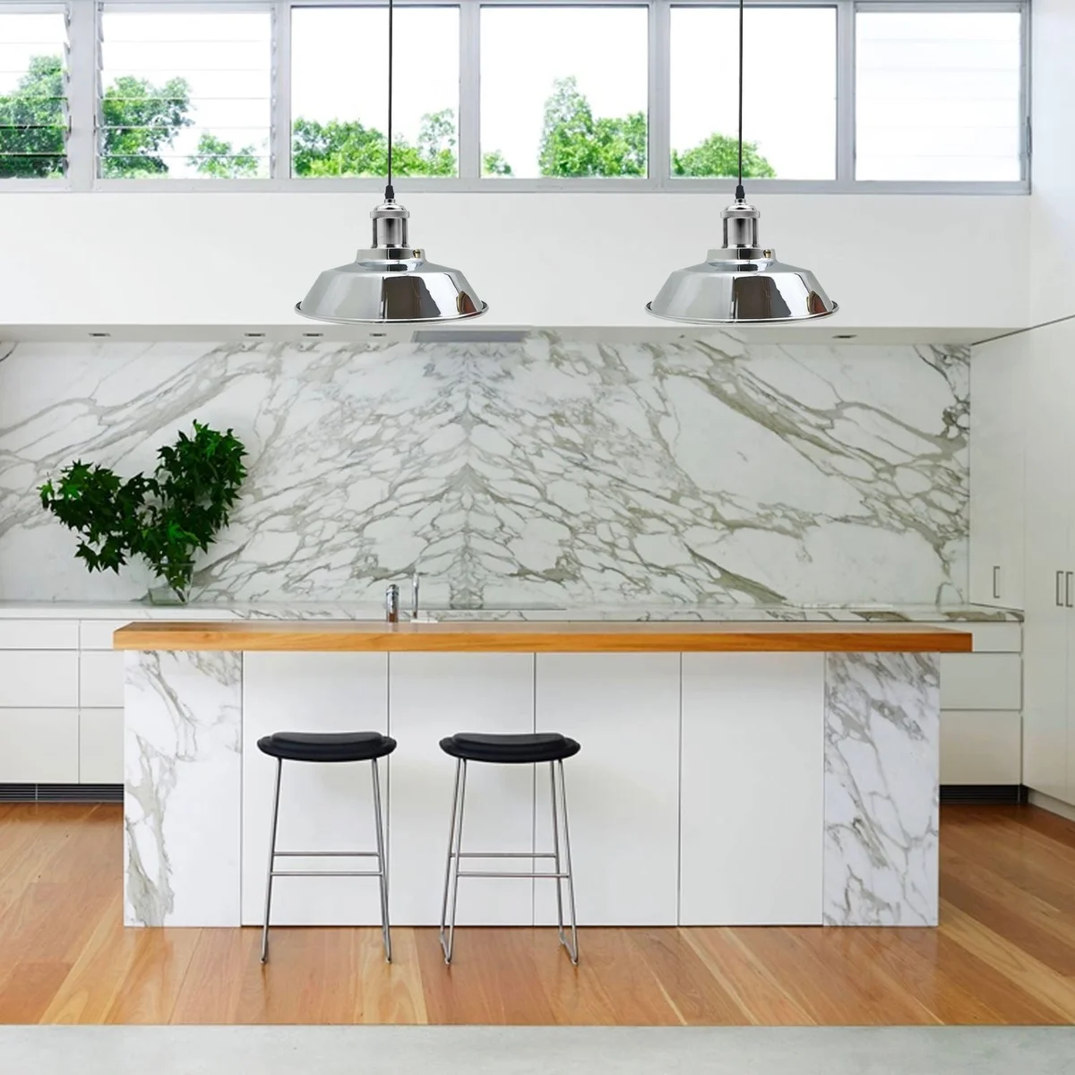 Satin nickel metal dome pendant light hanging from an adjustable base, white interior dome reflecting light.