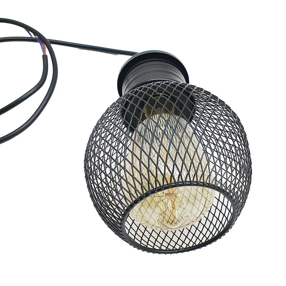 Three black iron and PVC pendant cages hanging from ceiling, each with a round ball shade, forming a retro loft lighting set.