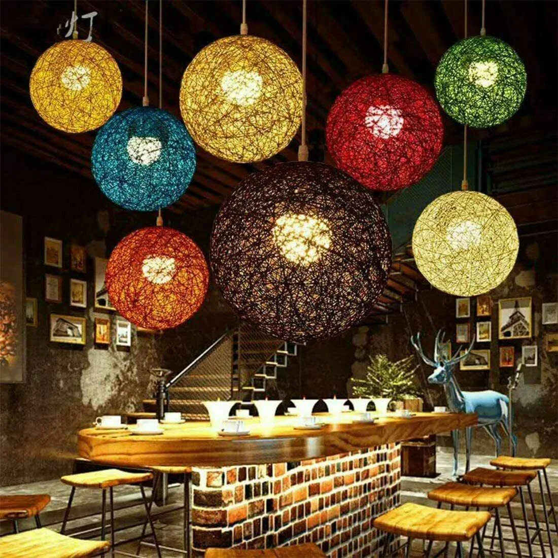 Rattan pendant light with woven wicker globe shade hanging on wall, green finish, E27 socket