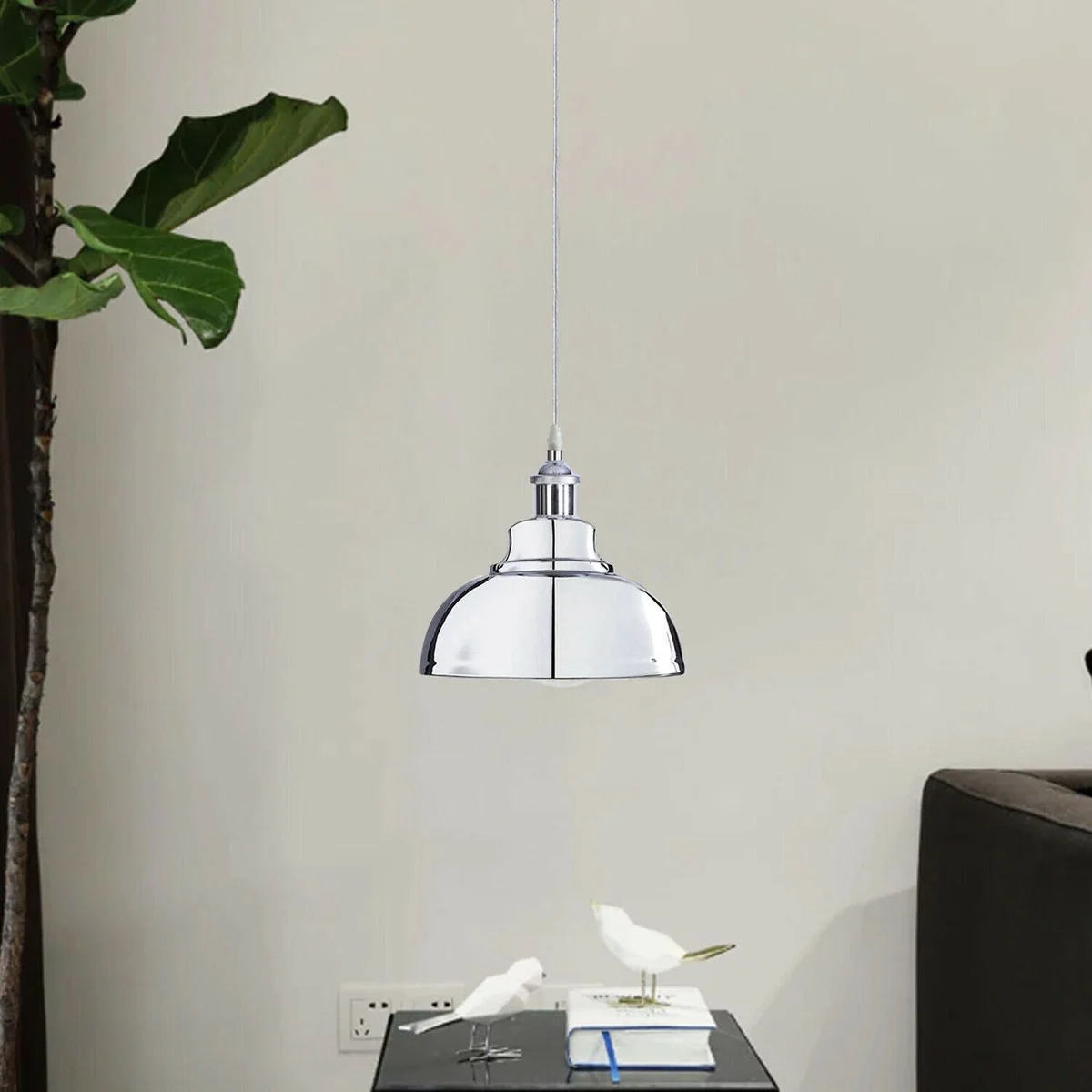 Chrome metal adjustable wire pendant light suspended from ceiling, featuring a polished chrome finish and a white hood.