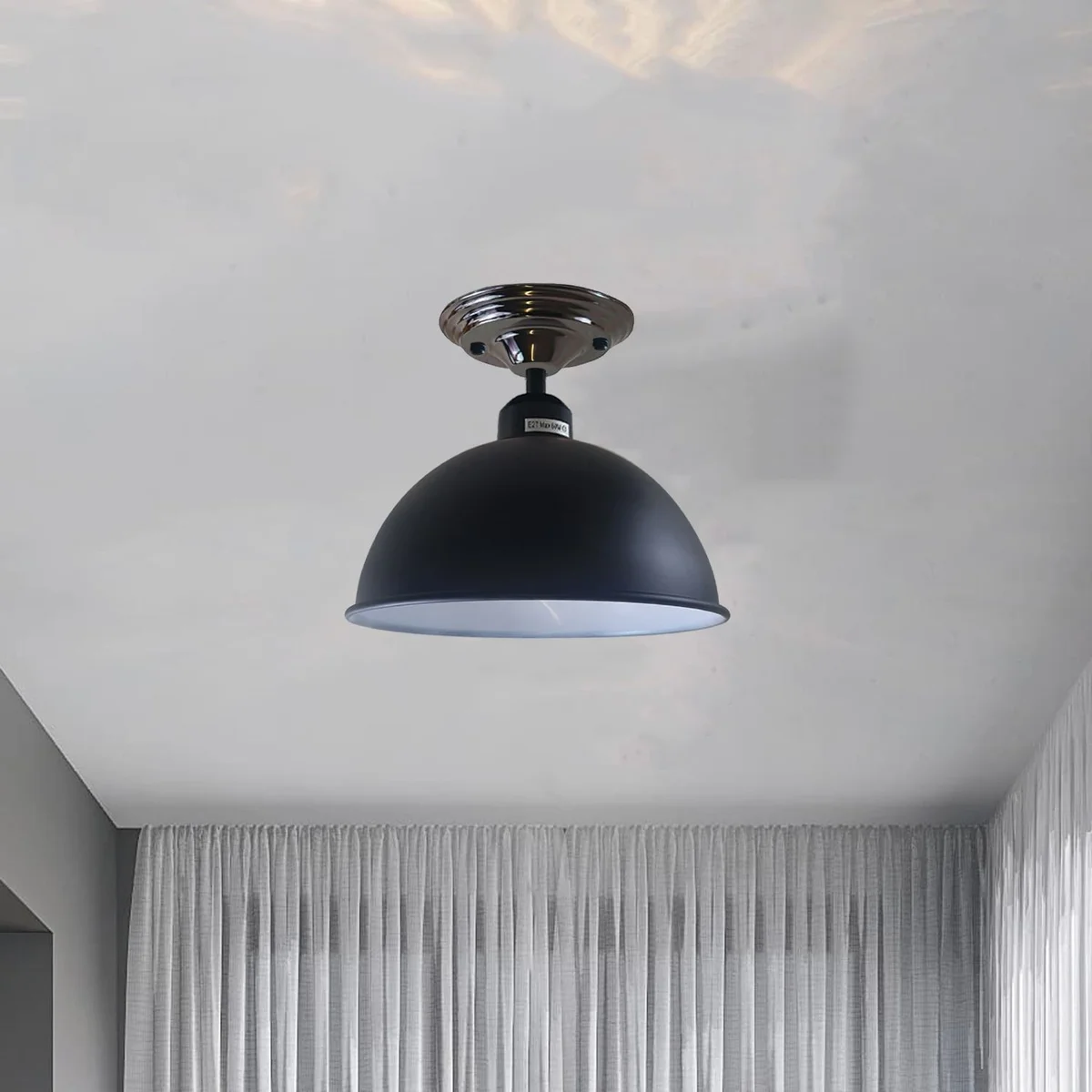 Black metal semi flush ceiling light, 14cm wide by 4cm high, with metal shade and E27 lamp holder, mounted on a ceiling.