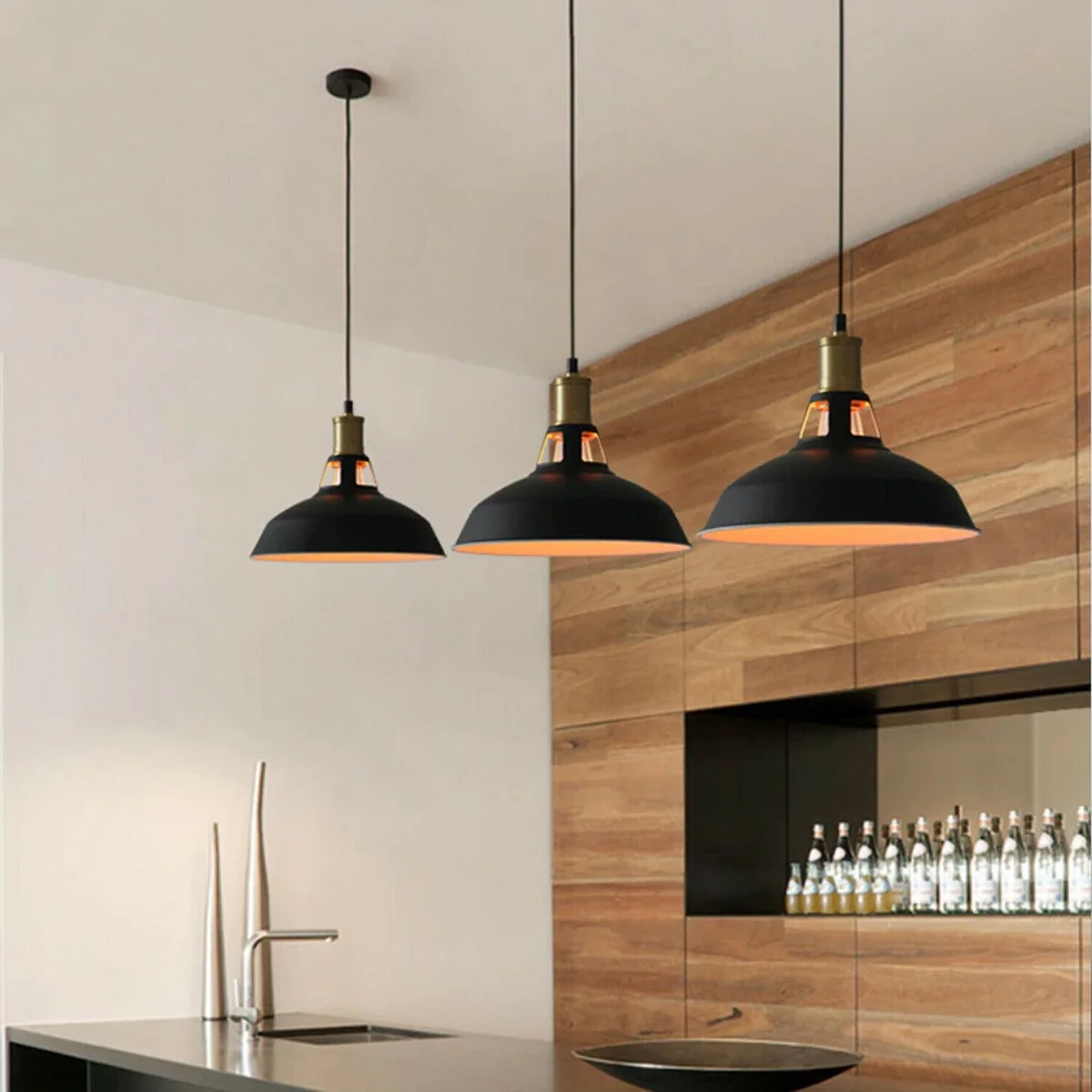 Black metal pendant light with iron shroud, slotted shade, 95‑cm cable hanging over kitchen island.