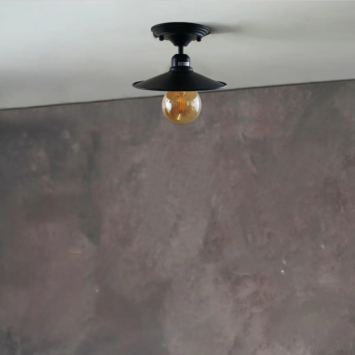 Black metal ceiling mounted lamp with sleek shade and E27 bulb holder, ready for warm lighting.