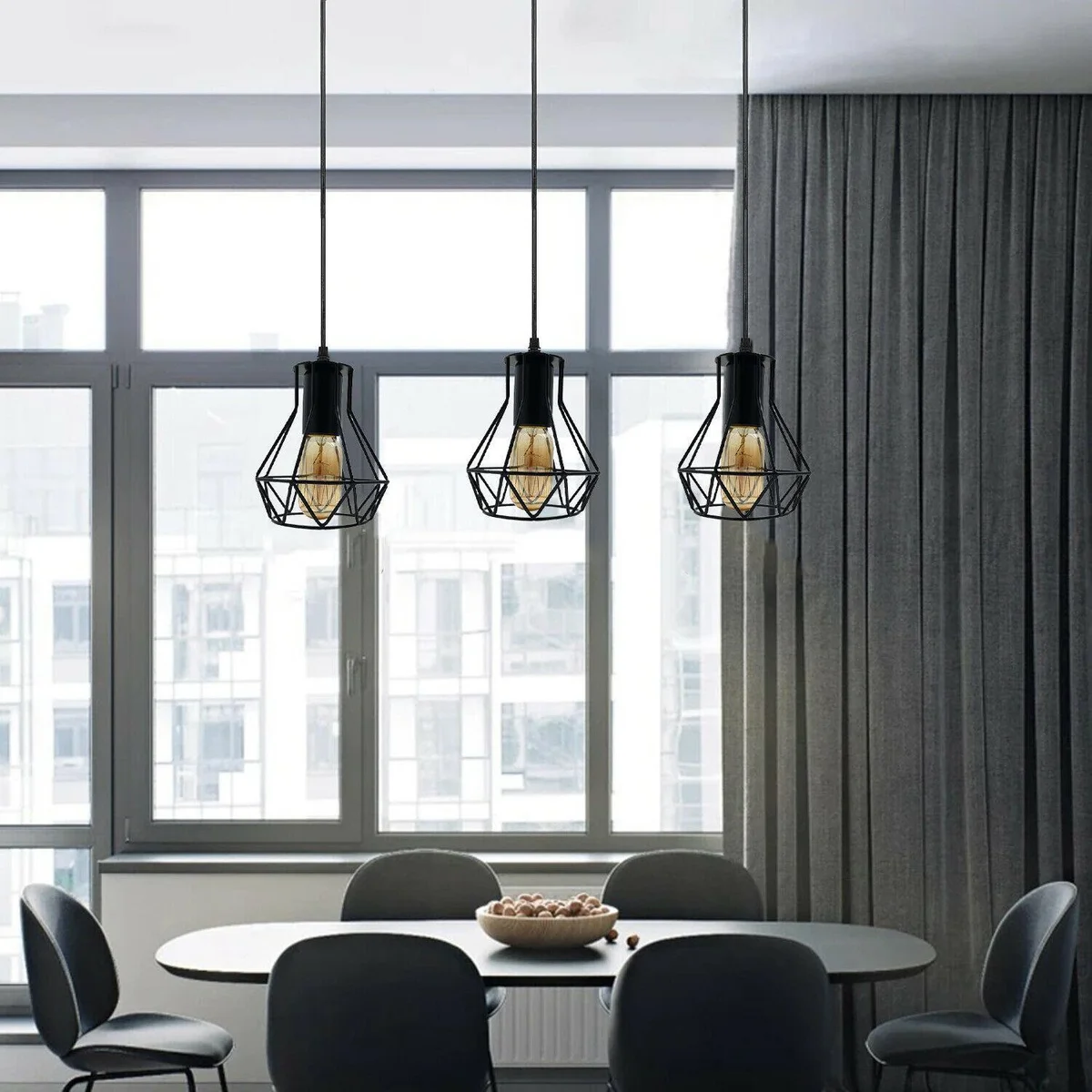PVC cable ceiling light hanging from ceiling with black metal cage and 3 rectangular heads.