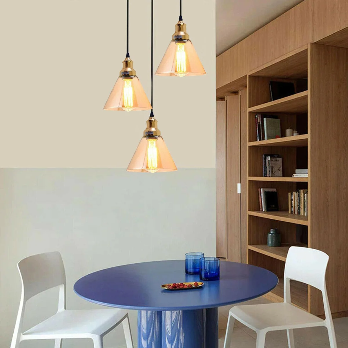 Industrial pendant light with 3 amber glass shades and metal base, featuring adjustable cables