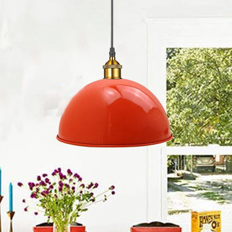 Metal ceiling lamp with orange‑white shade hanging above a kitchen island, iron frame, black finish.