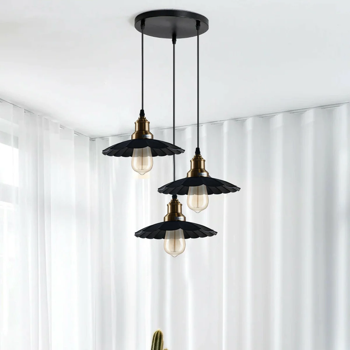 Three black pendant lamps in a wavy metal design, each with a black pendant lamp base and a 95 cm PVC cable.