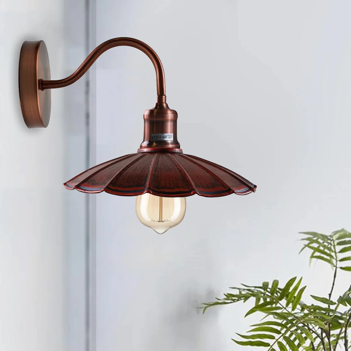 Rustic wall sconce with red metal umbrella shade, copper arm and ceiling rose, adjustable for directional lighting.