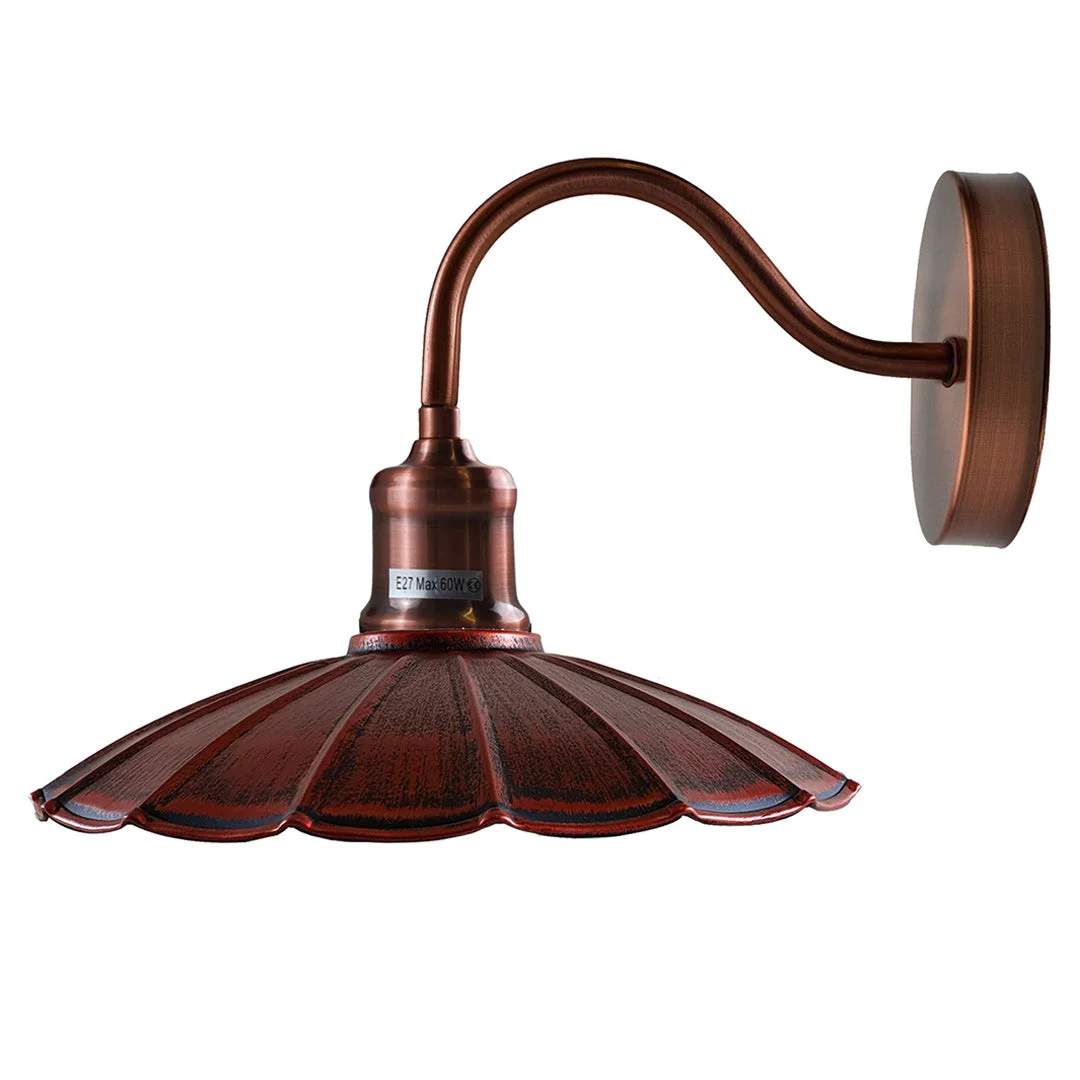 Rustic red metal industrial wall light with copper arm and shade, adjustable arm, housed in a copper ceiling rose.