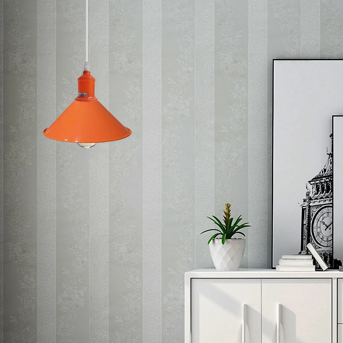 Orange ceiling light hanging from a polished metal pendant with a retro dome design.