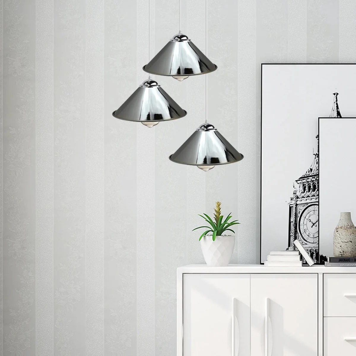 Chrome metal ceiling light with 3 pendant shades hanging from the ceiling.