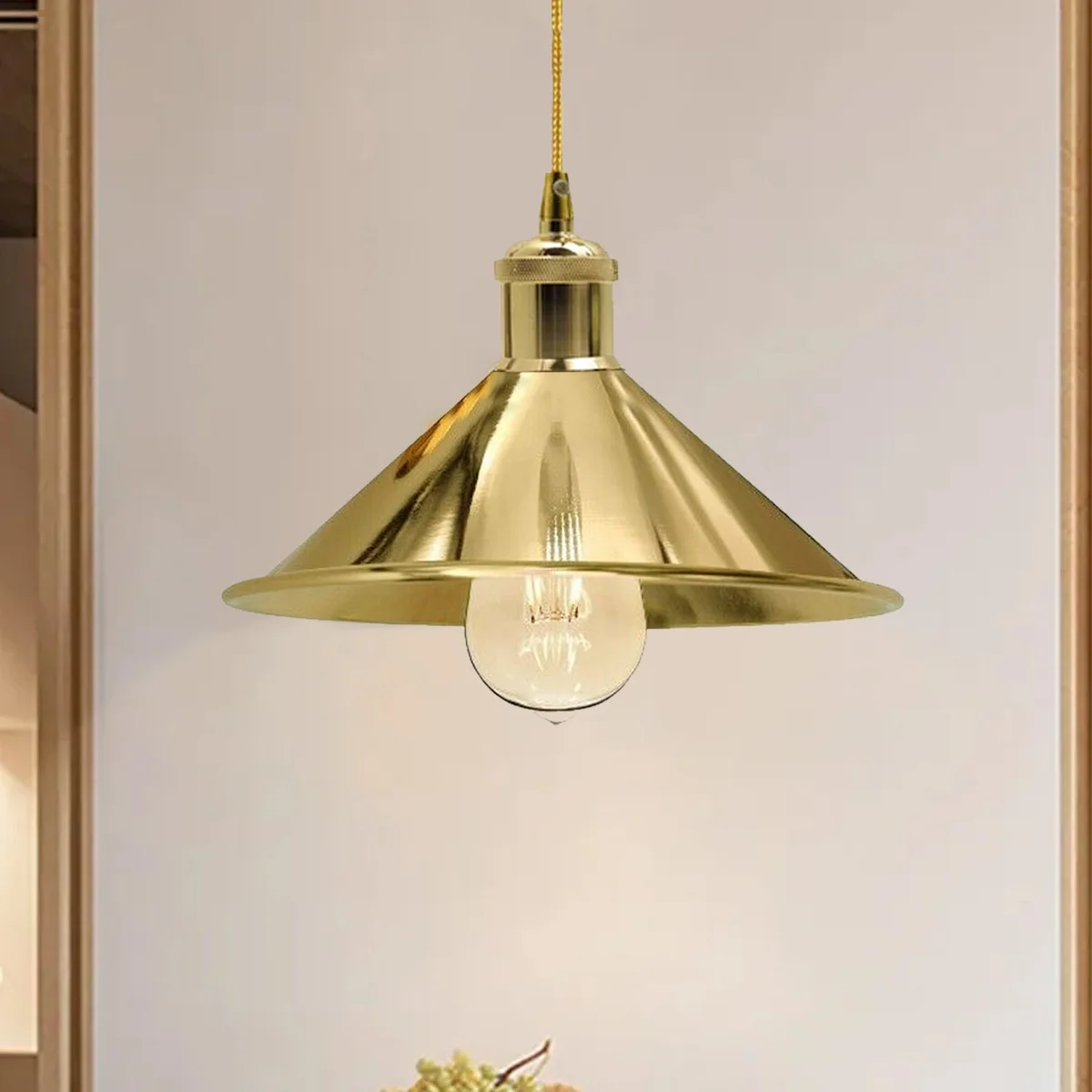 Rustic pendant light with metal wire frame in French Gold, round ceiling plate, 95cm cable, hanging over a table.