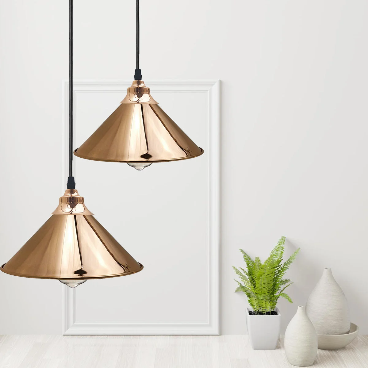 Gold pendant lights with sleek dome shade, metal base, adjustable cable, modern industrial design.