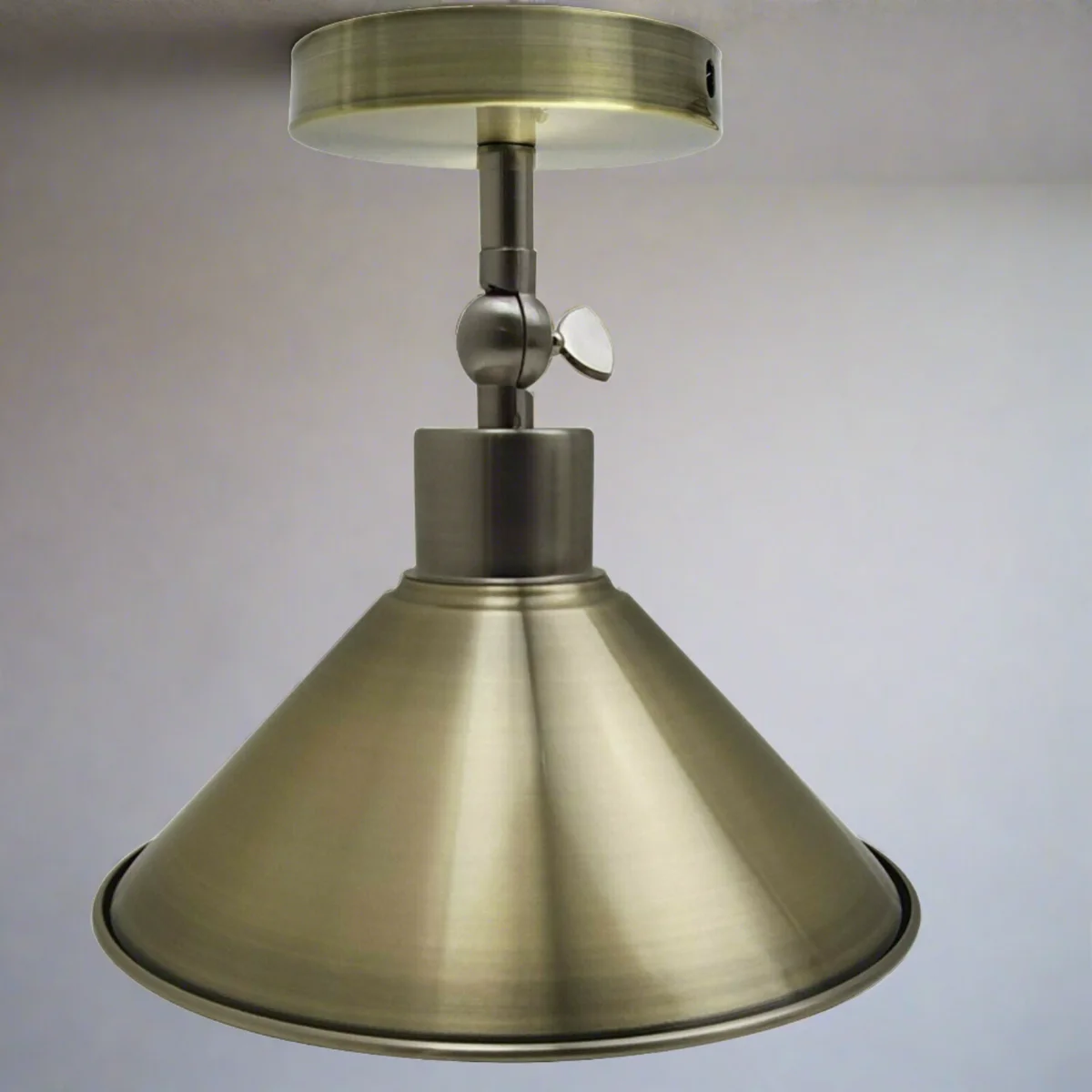 Green brass cone lampshade adjustable angle ceiling light set on a flat surface with base and holder.
