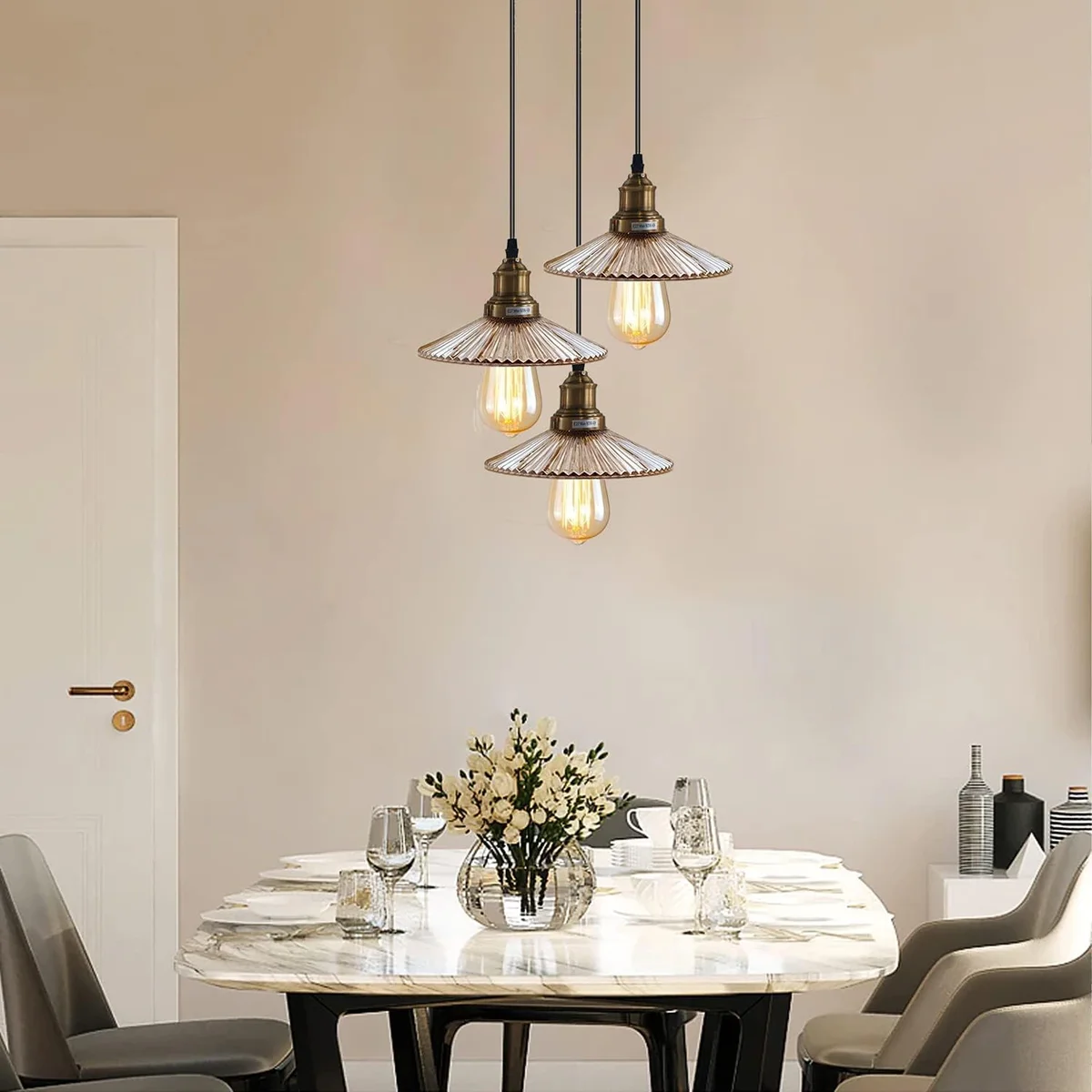 Three amber‑yellow glass pendant light fitting hanging from ceiling, featuring E27 lamp base and brass finish.