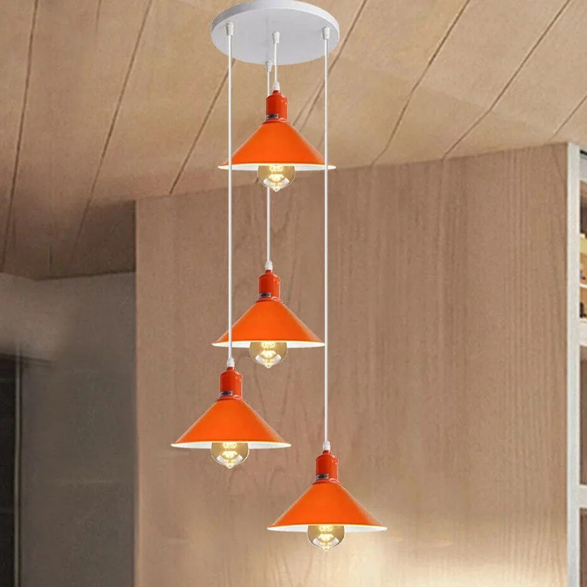 Retro modern ceiling pendant in orange and white with metal base, PVC cable, 4 light holders and four rounded shades.