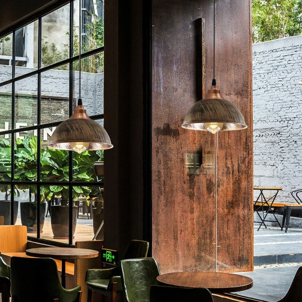 Modern pendant light on a ceiling, iron frame with polished black finish hanging in a minimalist pose.