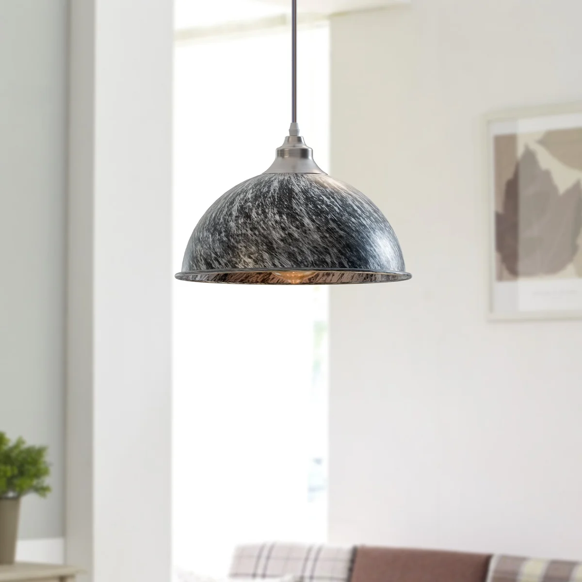 Modern pendant light in brushed copper finish hanging from ceiling, iron body with E27 base, casting warm romantic glow.