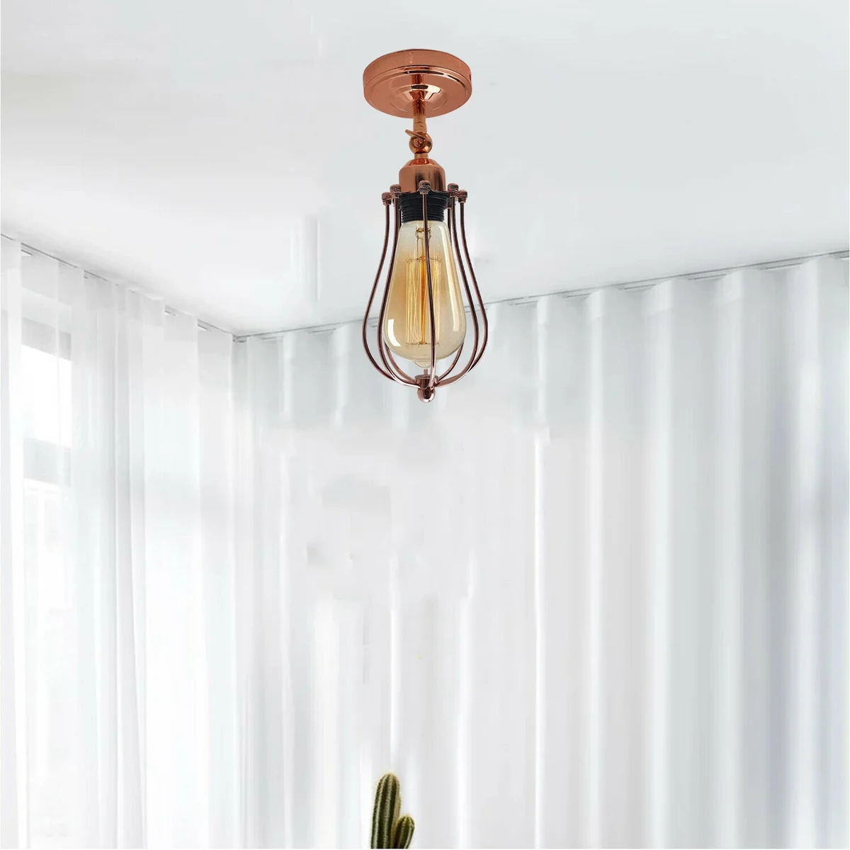 Hexagonal rose gold ceiling lamp with metal cage, adjustable arm, two socket openings.