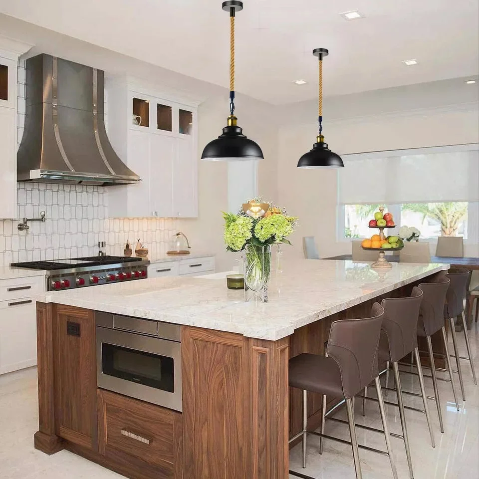 Metal shade pendant with clear metal lampshade and hemp rope dangling over kitchen island
