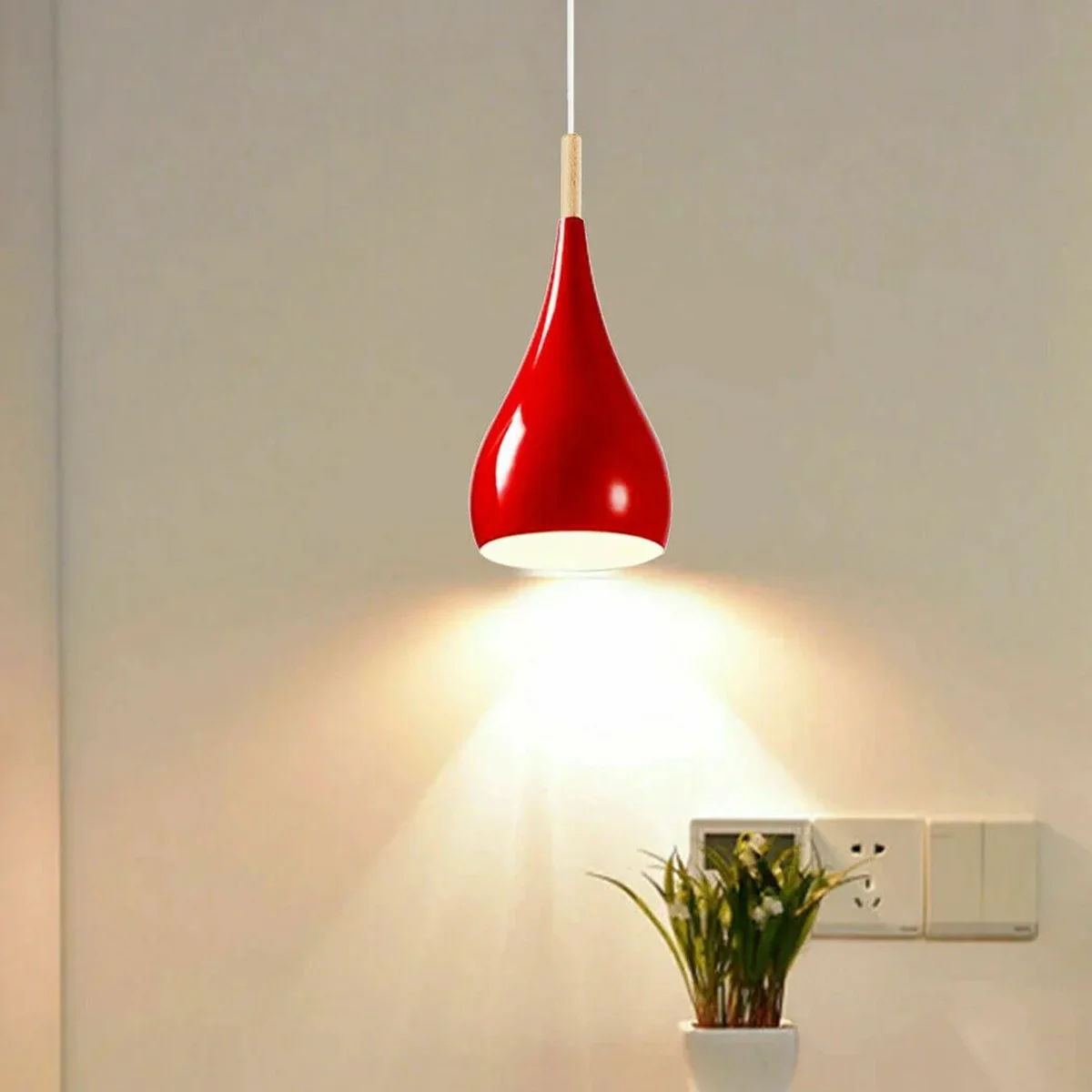 Red pendant ceiling light with metal frame and shade hanging from ceiling, LED bulb socket, suitable for modern interior