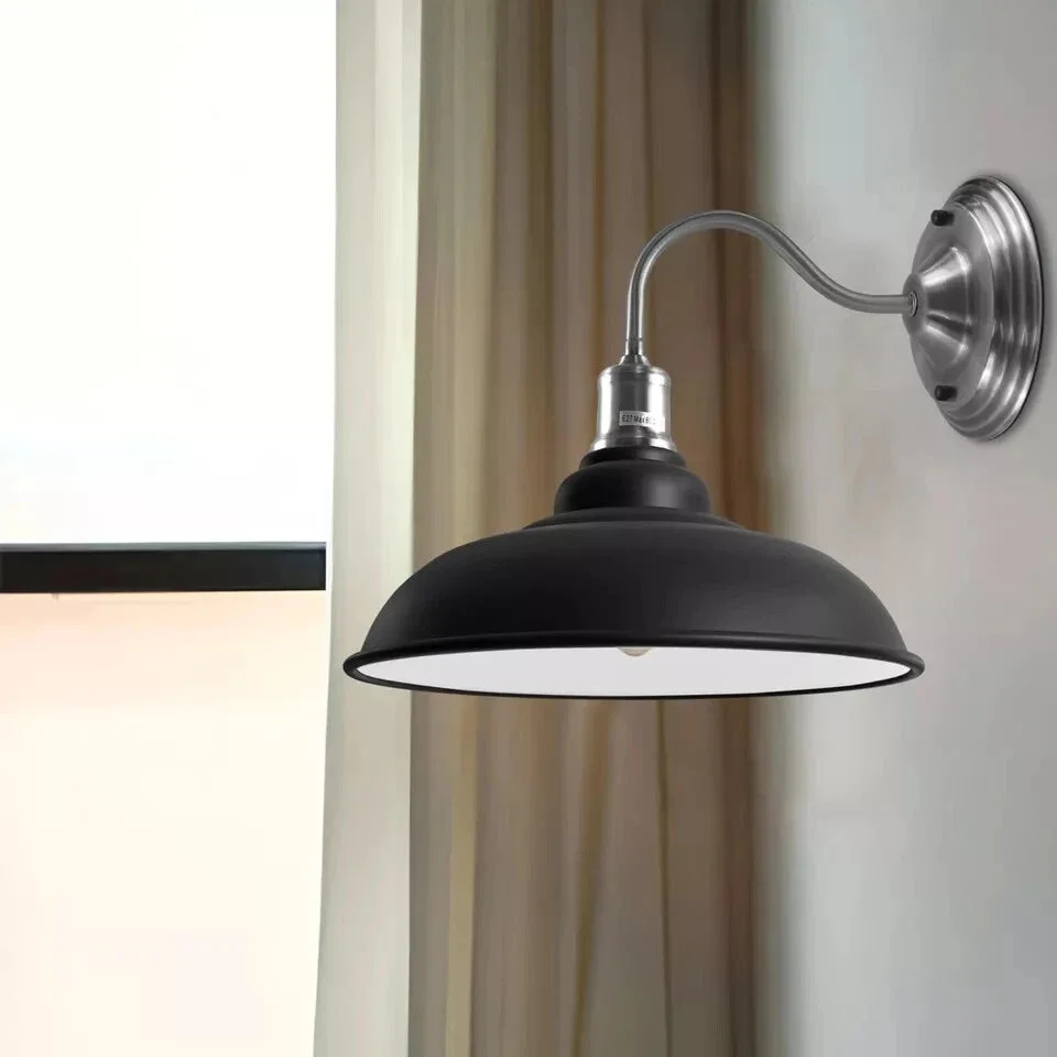 Black vertical gooseneck metal lampshade lighting fixture, a vintage metal wall light installed on a wall
