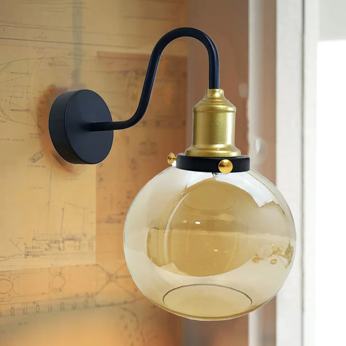 Amber glass wall light with metal back plate, globe shade, mounted on wall.