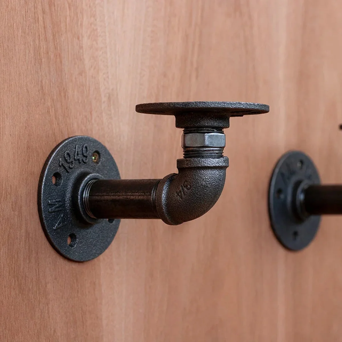 Black cast iron pipe fitting with hexagonal center and threaded ends for secure lighting and DIY projects installation