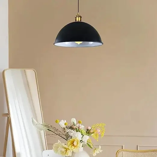 Black metal dome pendant light hanging in a modern room showcasing contemporary pendant lighting design