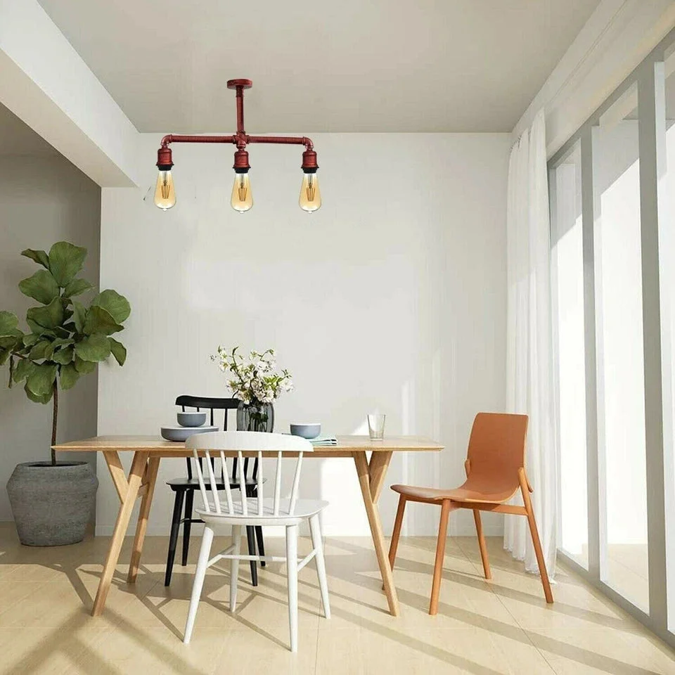 Three-light industrial pipe ceiling light with brushed silver metal pipes in retro Texas steampunk style