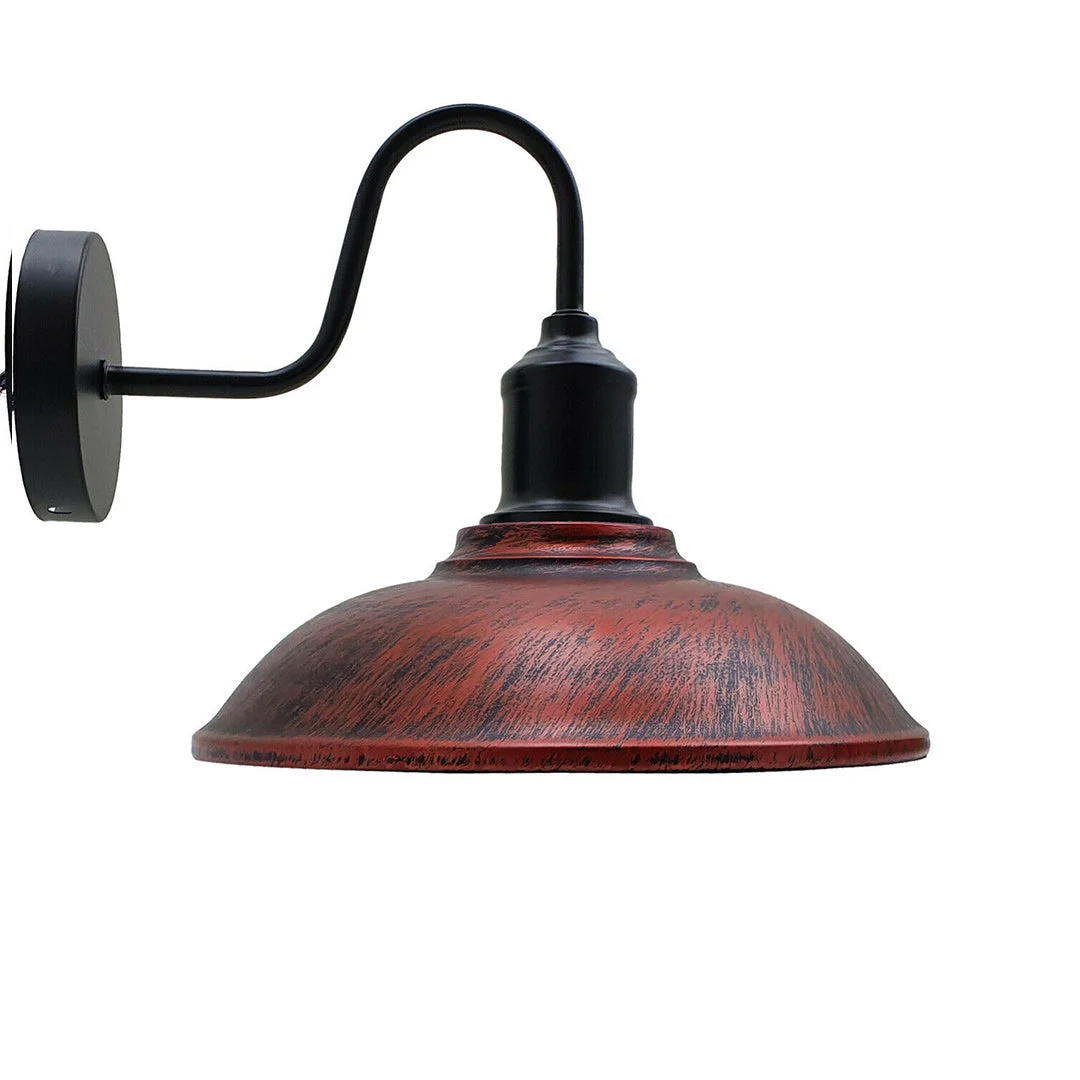 Industrial wall light with black arm, rustic red metal cage shade, and black ceiling rose mounted on white wall