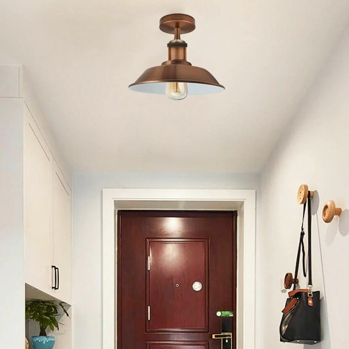 Vintage industrial ceiling light in green brass metal with bowl-shaped shade, semi-flush mount design against white background