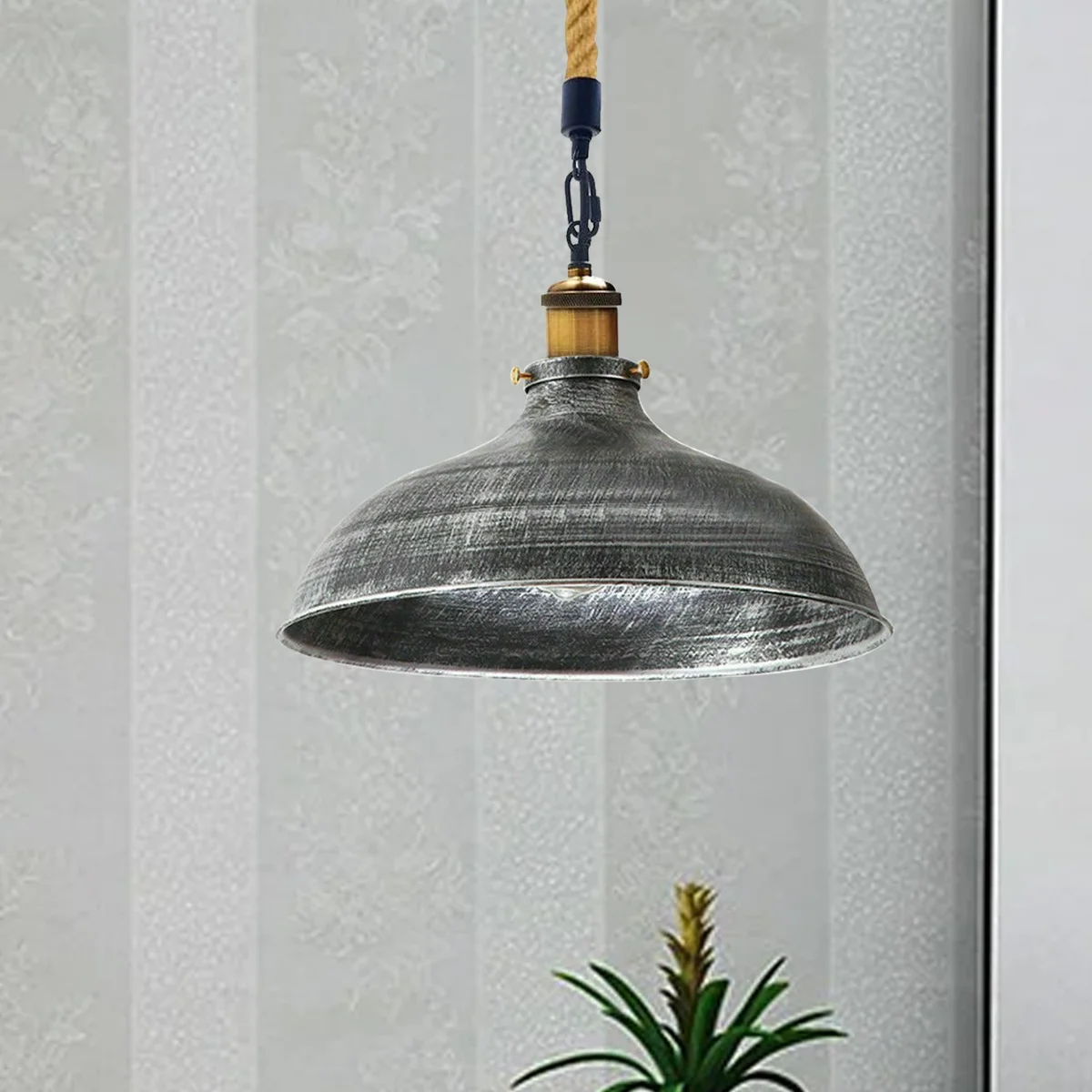 Brushed silver retro pendant lamp with metal shade and hemp rope hanging from ceiling, vintage industrial style