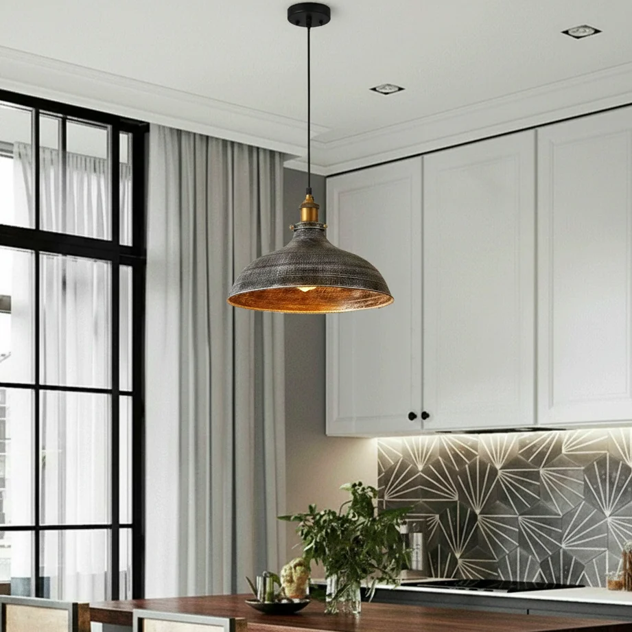 Vintage copper pendant light with wide metal dome shade and brushed finish hanging from adjustable cable against white background