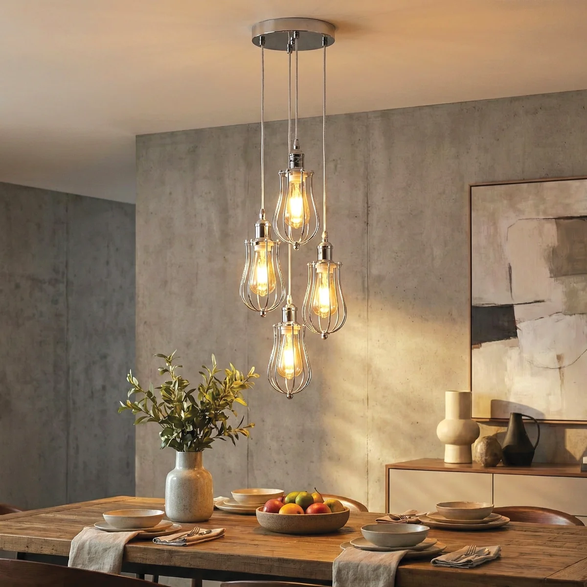 Chrome pendant chandelier with four decorative metal cages and adjustable PVC cables in a modern industrial style