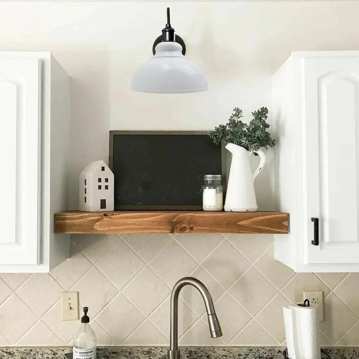 White curvy wall light lamp with cone-shaped shade and U-bend handle mounted on a white wall