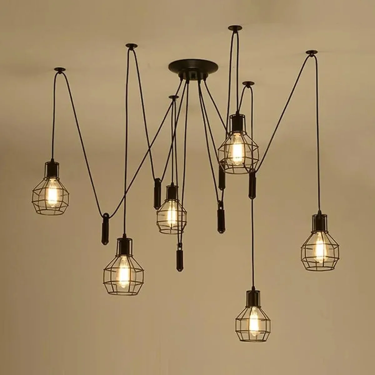 Adjustable spider pendant chandelier with six black metal wire cage lights and long adjustable cables in industrial style