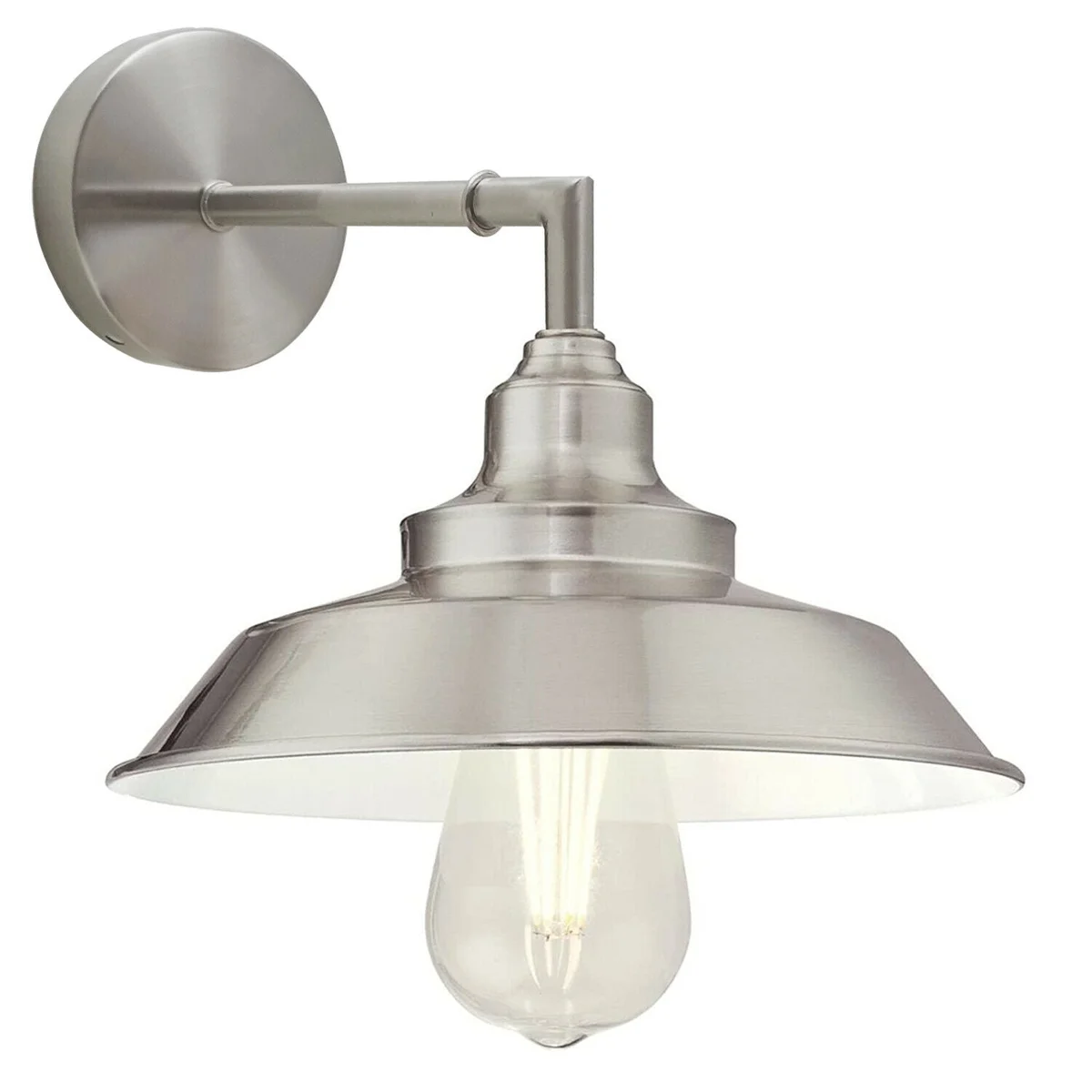 Antique brass wall light with adjustable arm and satin finish, mounted on a white wall next to a wooden desk