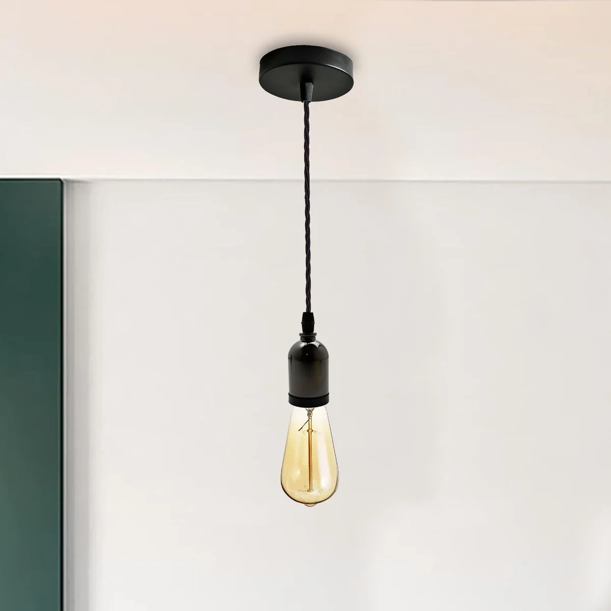 Black metal vintage pendant ceiling light with E27 holder and black twisted cord hanging from ceiling rose
