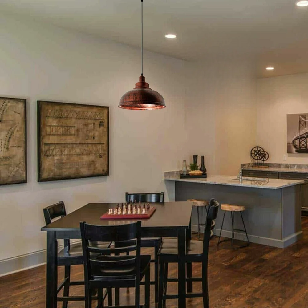 Rustic red metal industrial pendant light with cage design, suspended from ceiling with adjustable cable and E27 fitting